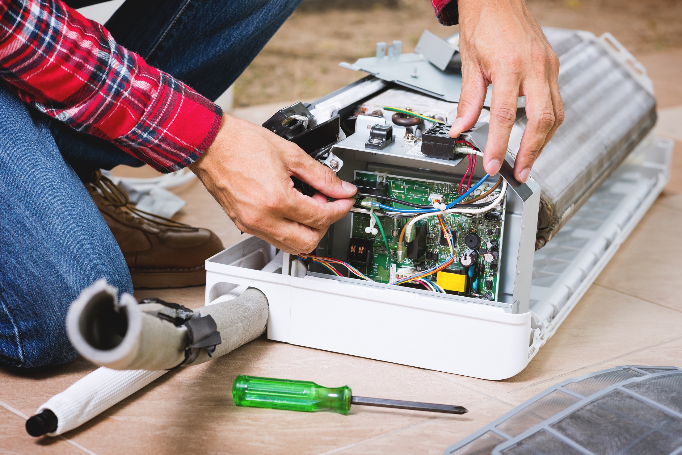 Air conditioning repair technician at work