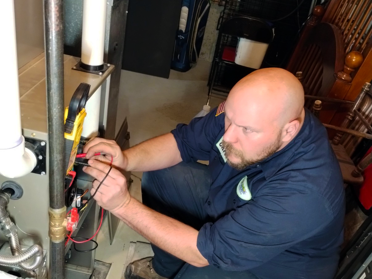 Price's HVAC technician performing planned furnace maintenance